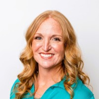 Headshot of Casey Brown, owner and founder of Boost Pricing wearing a blue blouse