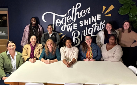 Brand Sway graduates sitting at a table.